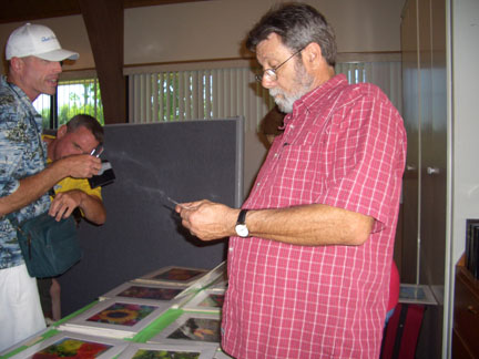 CCB members looks at assortment of art photos on sale